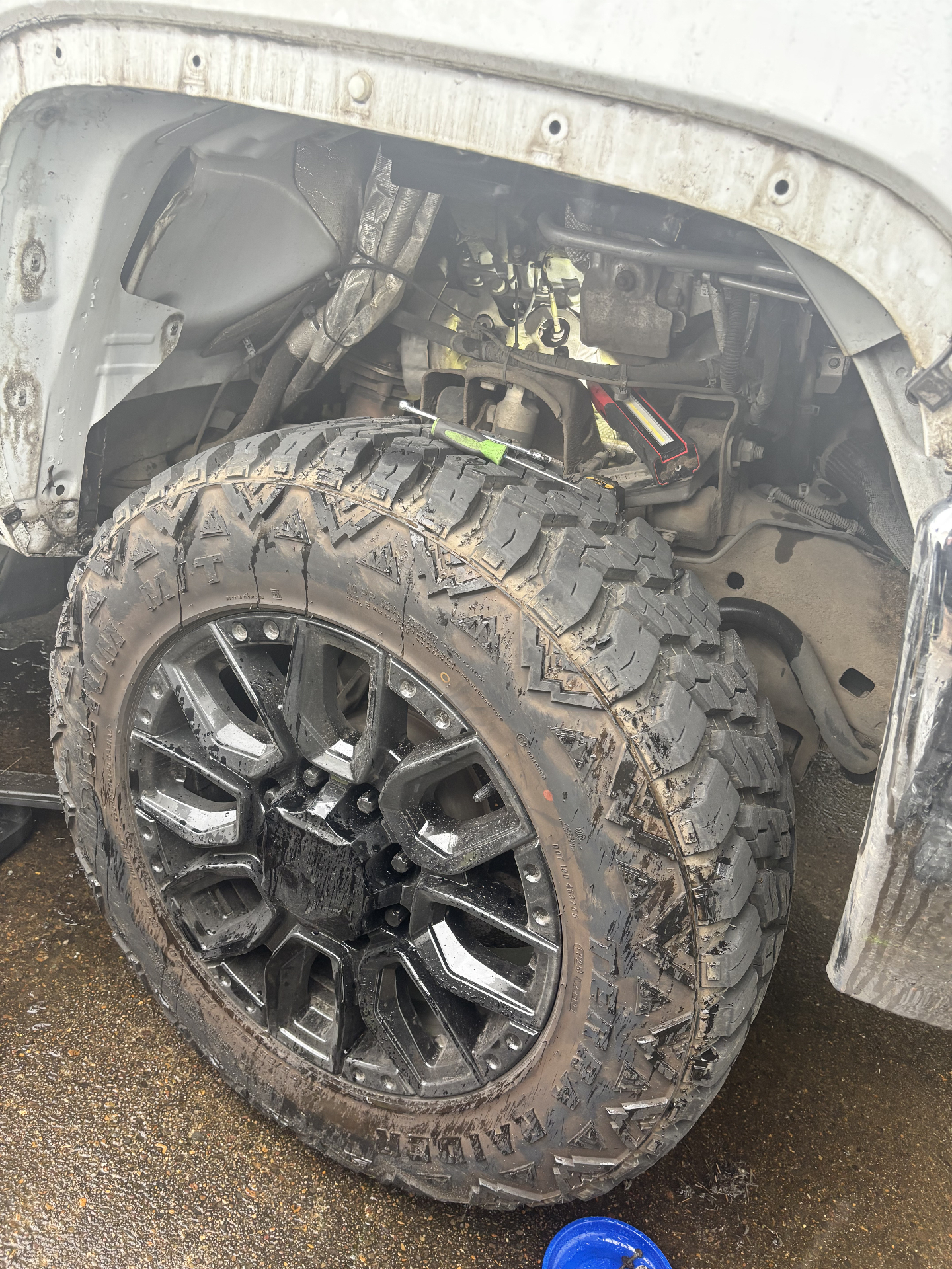 Lifted truck wheel and front-end suspension service on-site